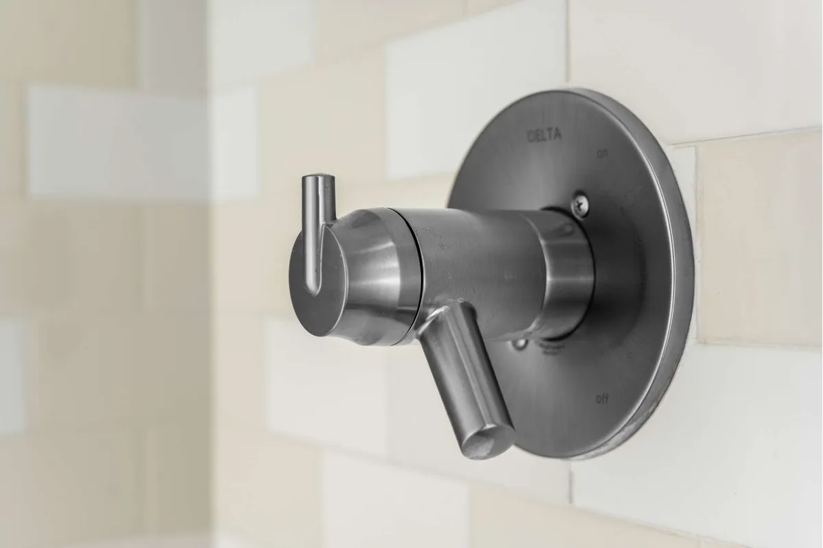 A contemporary bathroom scene featuring a modern faucet with a smooth metal finish, set against a subtle tile background. The overall feel is fresh and clean, suggesting a space designed for relaxation and rejuvenation.